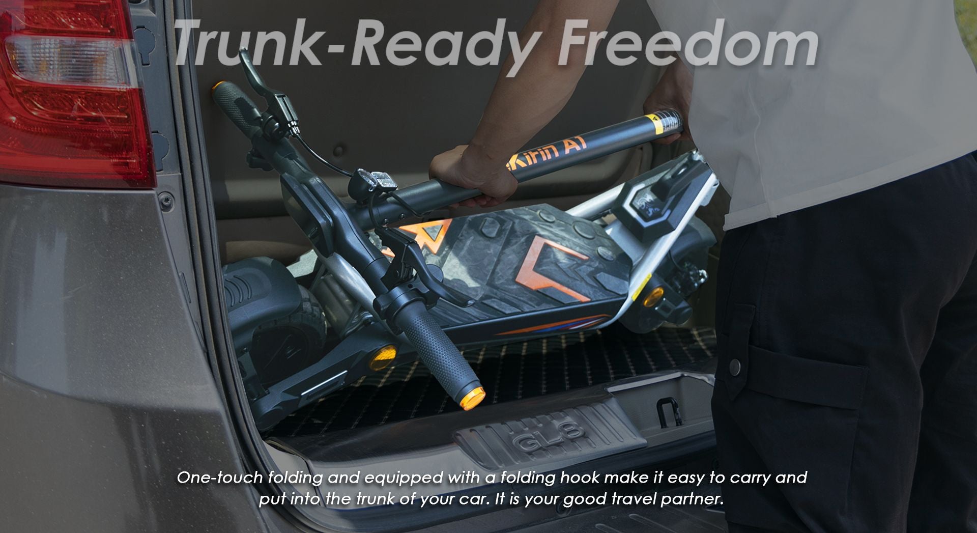 KuKirin A1 folded electric scooter being placed into car trunk for travel