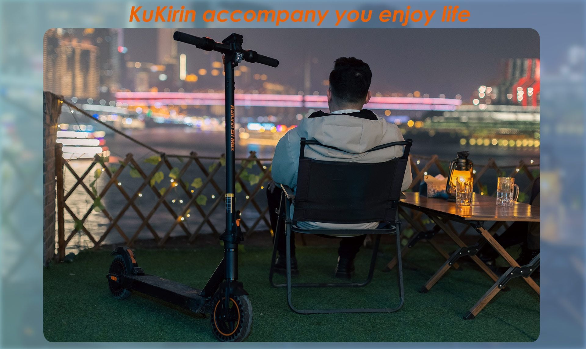 KuKirin S1 Max electric‑scooter placed beside user, night city waterfront leisure lifestyle scene
